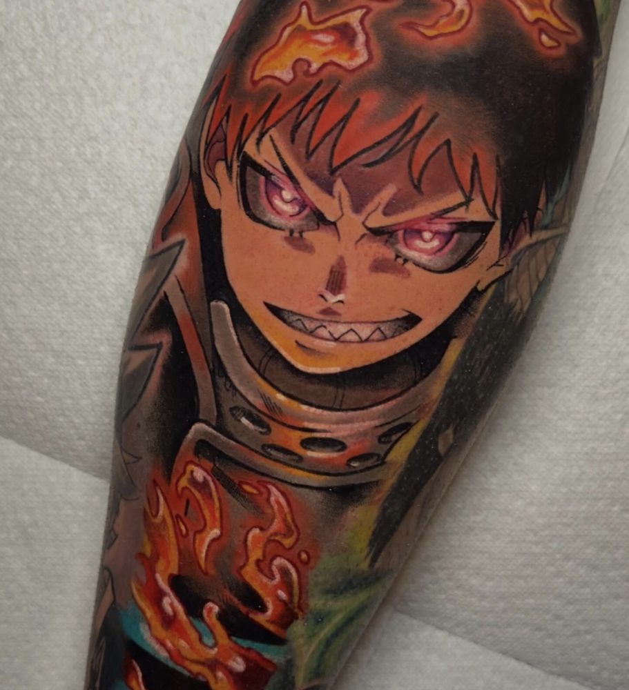 Color anime tattoo of Shinra Kusakabe from Fire Force with glowing eyes and fire effects, tattooed in Dallas