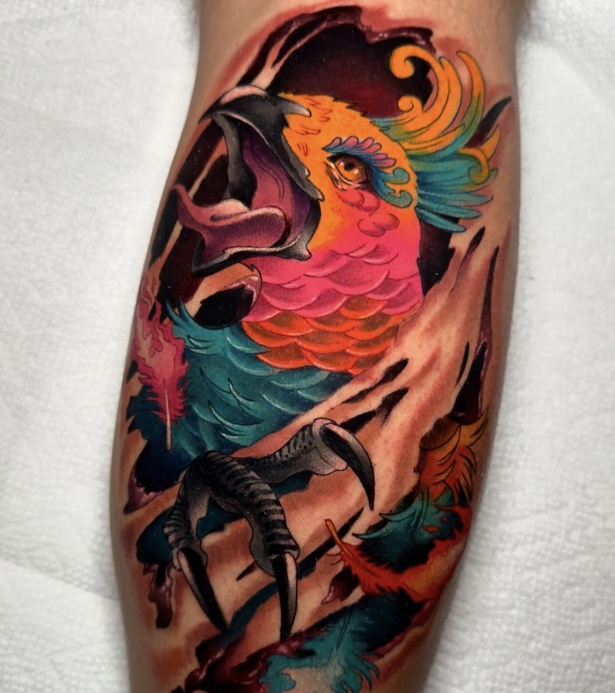 Neon color neotraditional tattoo of a phoenix within a skintear 